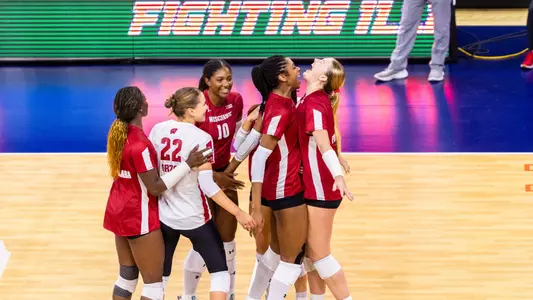 The Badgers celebrate after winning a point vs Illinois