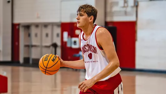 Gus Yalden dribbles the basketball during a practice