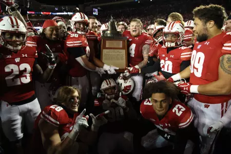 Wisconsin football celebrates with the Freedom Trophy after defeating Nebraska 24-17 in overtime on Saturday, Nov. 18, 2023 at Camp Randall Stadium in Madison, Wisconsin.