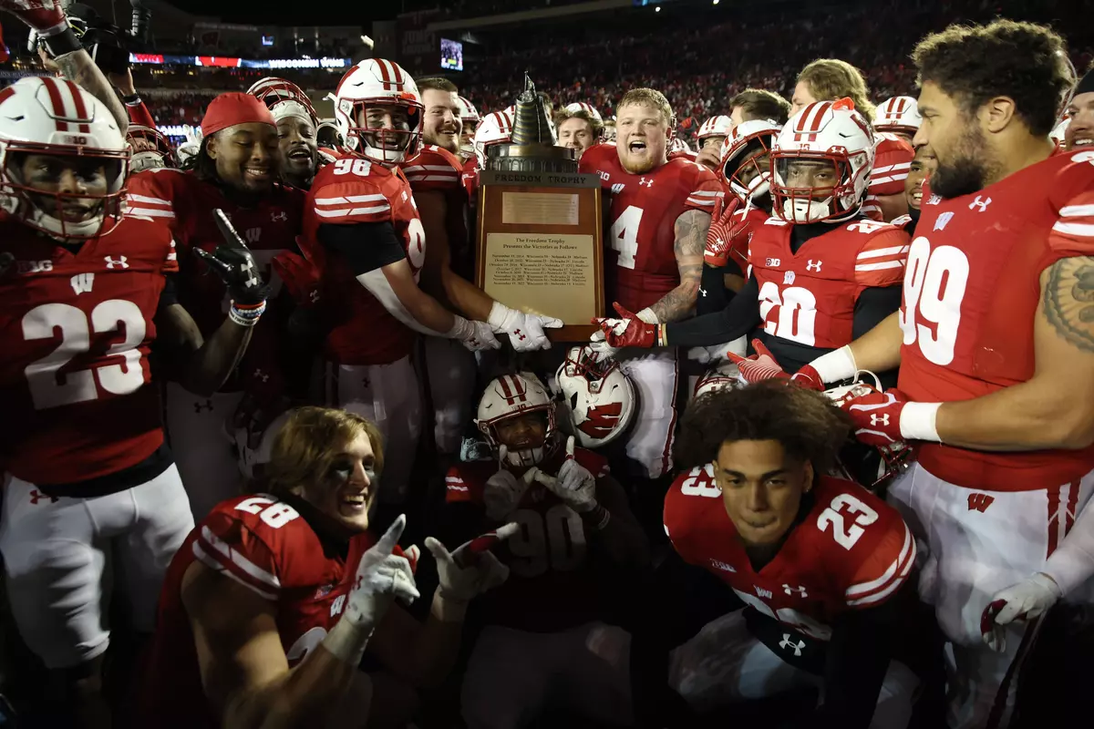 Wisconsin football celebrates with the Freedom Trophy after defeating Nebraska 24-17 in overtime on Saturday, Nov. 18, 2023 at Camp Randall Stadium in Madison, Wisconsin.
