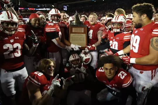 Wisconsin football celebrates with the Freedom Trophy after defeating Nebraska 24-17 in overtime on Saturday, Nov. 18, 2023 at Camp Randall Stadium in Madison, Wisconsin.