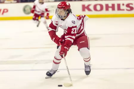 Sophomore defenseman Tyson Jugnauth controls the puck.