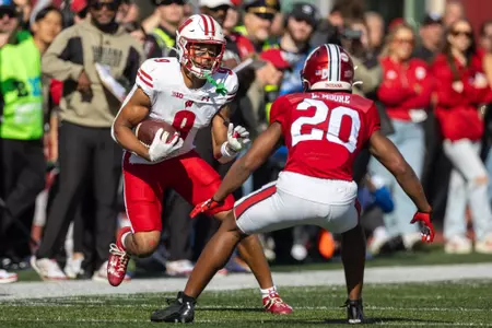 Wisconsin football wide receiver Bryson Green (9) carries the ball down field evading a Indiana defender during Wisconsin's NCAA football game at Indiana on Saturday, Nov. 4, 2023 in Bloomington, Indiana.