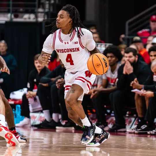 Kamari McGee dribbles past a screen