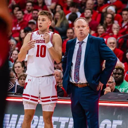 Isaac Lindsey and Coach Gard talk on the sideline