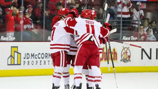 Members of the Wisconsin men's hockey team celebrate scoring a goal against Ohio State.