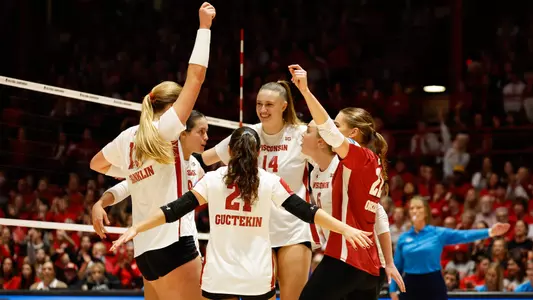 The Badgers celebrate a point on the court.