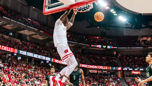 AJ Storr dunks the basketball during a game