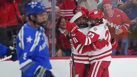 Simon Tassy and Sawyer Scholl celebrate scoring a goal against Air Force at the 2023 Holiday Face-Off tournament.