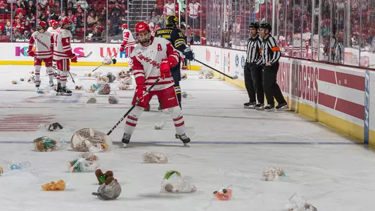 Mathieu De St. Phalle helps clear ice during the Teddy Bear Toss
