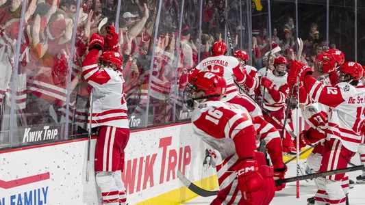 The Wisconsin men's hockey team celebrates its victory over the Ohio State Buckeyes.