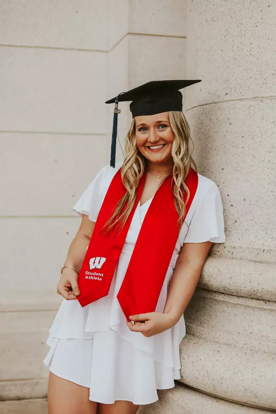 Joslyn Boyer, Wisconsin volleyball, graduation photo with cap, gown and red UW student-athlete sash