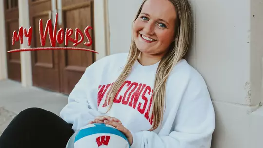 Joslyn Boyer, Wisconsin Volleyball, sitting outside the UW Field House holding a volleyball with My Words logo superimposed over the image