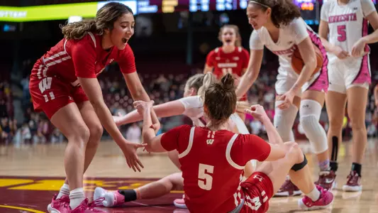 Julie Pospisilova being picked up and cheered on after taking a charge