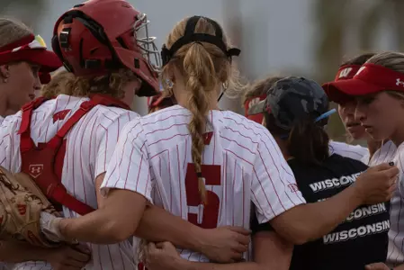 Softball team huddled together