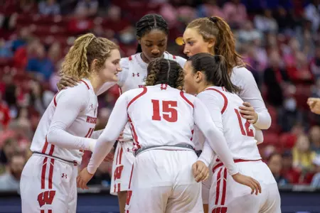 Team huddles at mid-court during the game