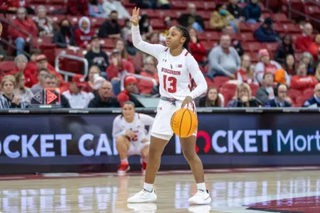 Ronnie Porter calls a play from the top of the key, while dribbling the ball.