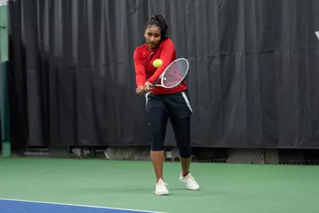 Ariel Johnson swings her racket during a match
