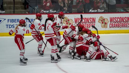 Wisconsin women's hockey celebrates a thrilling overtime win against No. 1 Ohio State Buckeyes at LaBahn Arena on Feb. 18, 2023