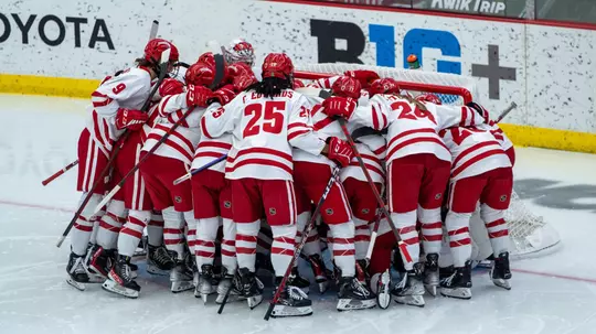 Wisconsin women's hockey huddles around the goal before a game against the Ohio State Buckeyes on Feb. 18, 2023 at LaBahn Arena