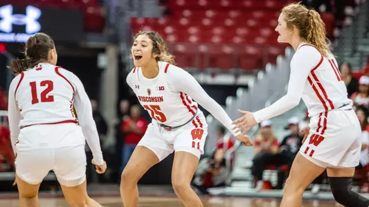 The women's basketball team celebrating after a basket