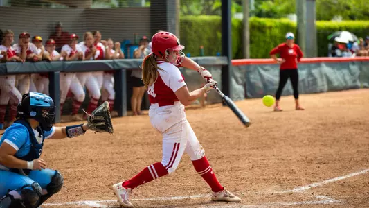 Brooke Kuffel swinging bat and hitting ball