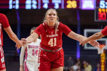 Sara Stapleton gives her teammates high fives.