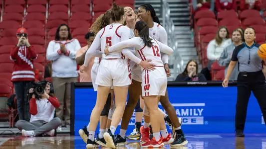 The women's basketball team celebrating after a blocked shot
