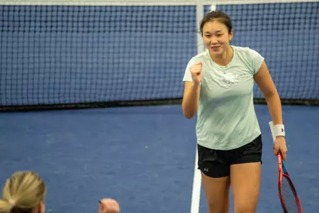 Xinyu Cai celebrates during a match