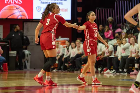 Brooke Schramek and Avery LaBarbera give each other a high five