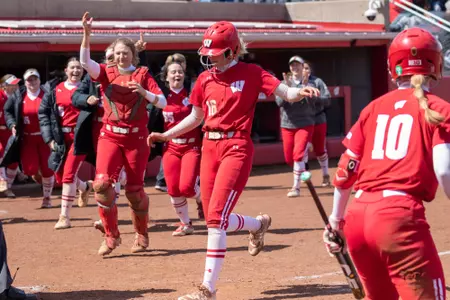 Wisconsin player scoring with team cheering behind her