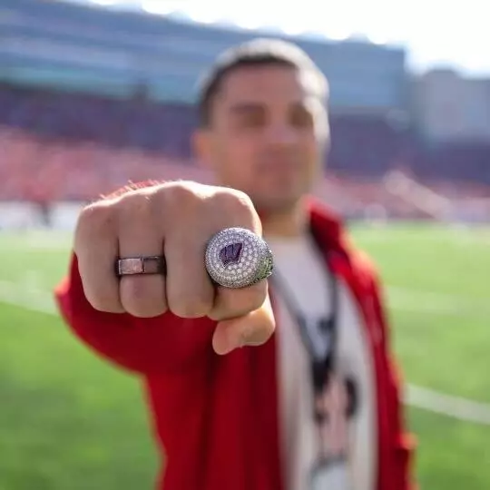 Austin Gomez shows his Big Ten Championship ring during Wisconsin football game