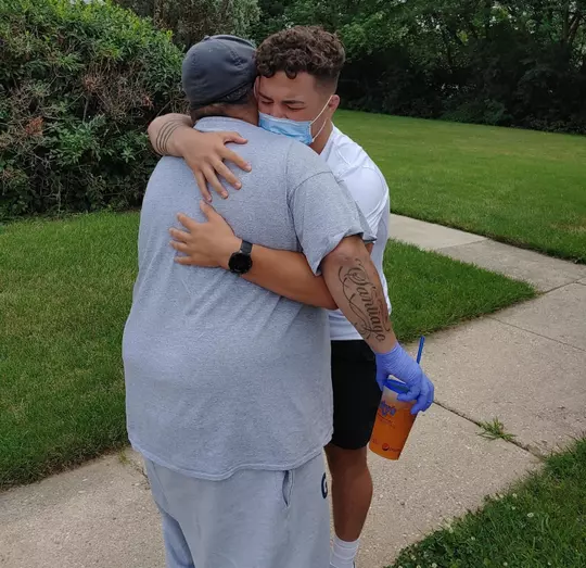 Austin Gomez hugs his father Hector after his father leaves the hospital and an extended stay due to COVID