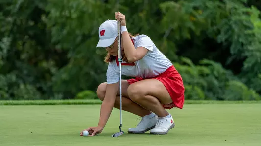 Chloe Chan, women's golf, lines up the ball for a putt at the 2022 Badger Invitational at University Ridge Golf Course in Madison, Wis.