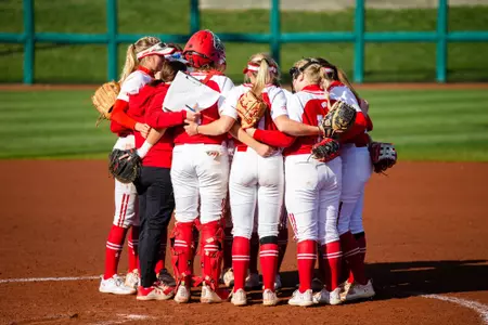 Wisconsin softball team in huddle on mound