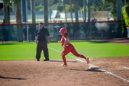 Bree Mitchell running around first base