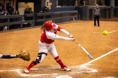 Katie Keller reaching to hit the ball