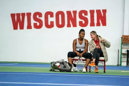 Head coach Kelcy McKenna gives Ariel Johnson instructions