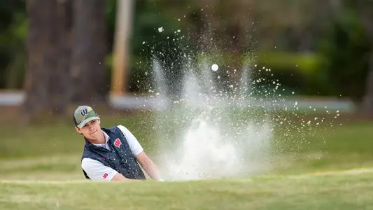 Cameron Huss hits a ball out of the bunker