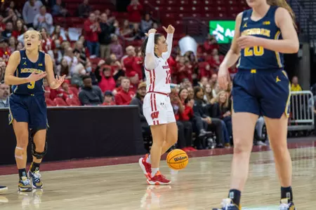 Avery LaBarbera pumps up the crowd with her arms.