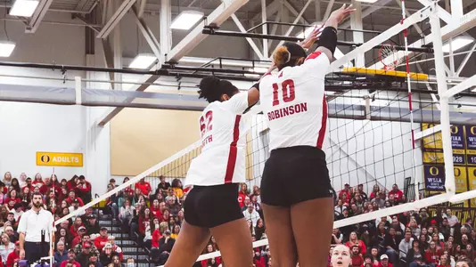 Carter Booth and Devyn Robinson go up for block against Marquette
