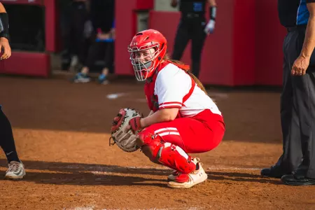 Eden Dempsey smiling at the camera catching behind the plate