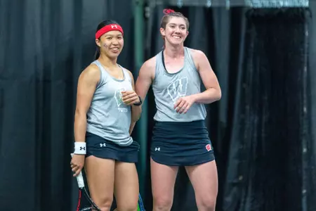 Charmaine Seah and Taylor Cataldi smiling during their doubles match against Northwestern