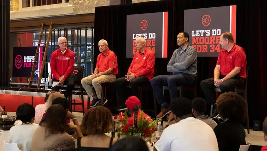 Matt Lepay interviews former coaches of Wisconsin Basketball at an event for Howard Moore