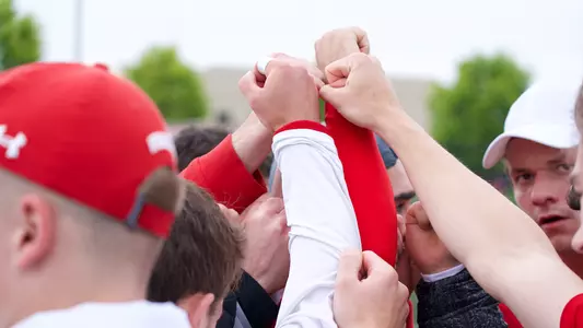 Men's tennis team huddle at Big Ten Tournament