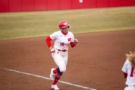Brooke Kuffel smiling running around the bases after home run
