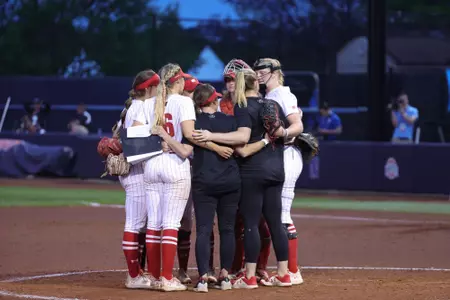 Badger softball team huddled together