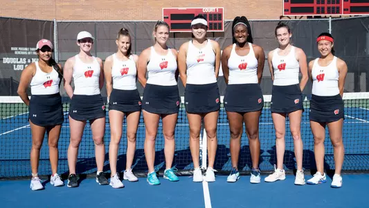 The eight members of the women's tennis team standing in line for a team photo