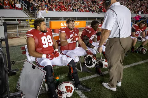 Wisconsin Badgers assistant coach Ross Kolodziej talks to defensive linemen Matt Henningsen (92) and Isaiah Mullens (99) during an NCAA college football game against the Army Black Knights, Saturday, Oct. 16, 2021, in Madison, Wis. The Badgers won 20-14. (Photo by David Stluka/Wisconsin Athletic Communications)