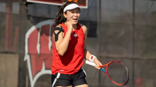 Xinyu Cai fist pumping after winning a point in a match at Nielsen Tennis Stadium